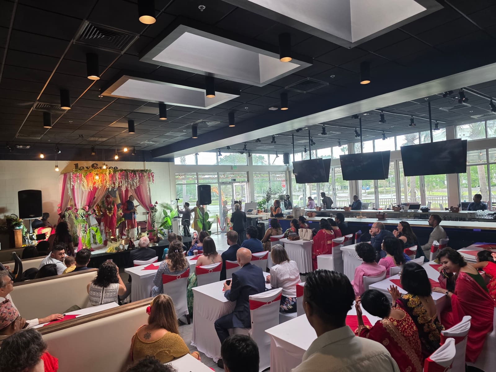 Guests seated at decorated tables during a Nepali wedding ceremony at JaxSpice