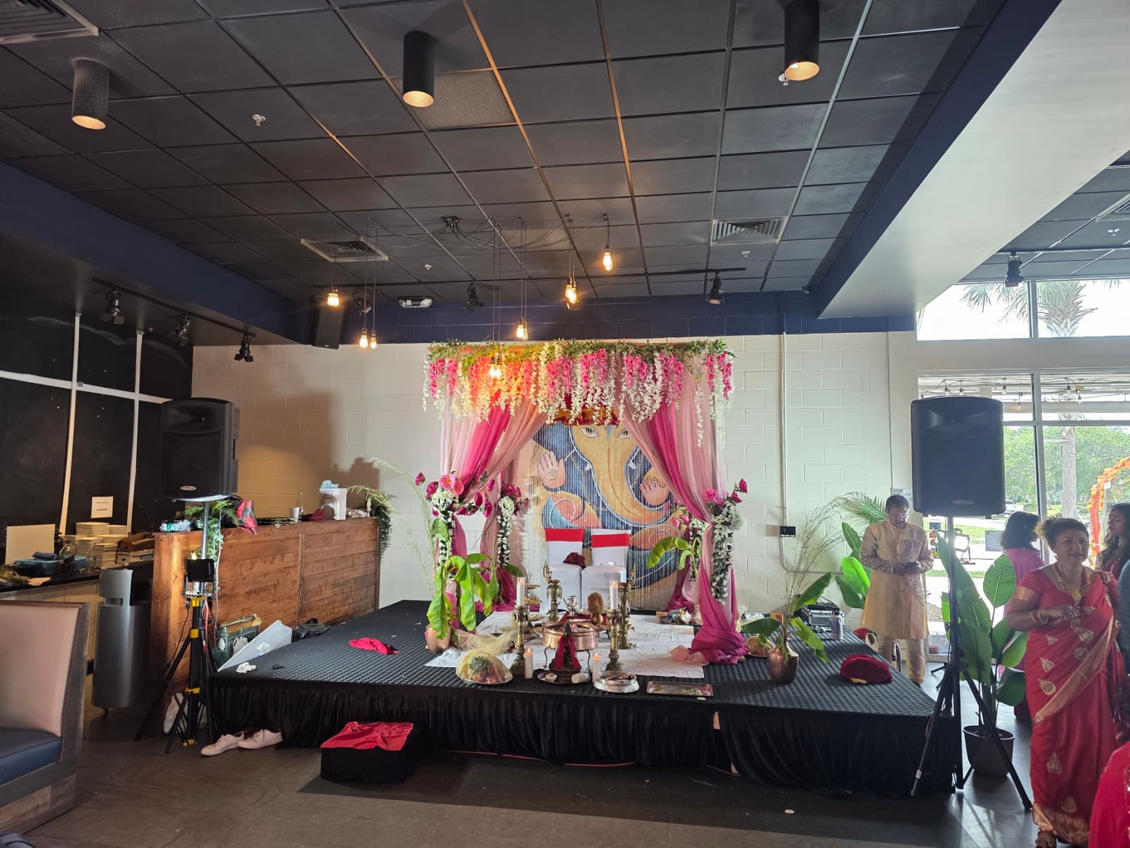 Stage decorated with flowers and drapery for a wedding celebration